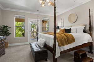 Carpeted bedroom with ceiling fan, ornamental molding, and access to outside