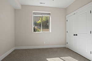 Unfurnished bedroom featuring carpet