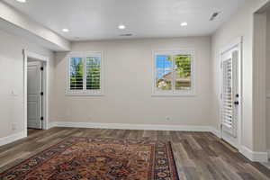 Interior space featuring plenty of natural light and dark hardwood / wood-style floors