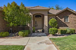 View of exterior entry with a lawn