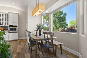 Dining space featuring hardwood / wood-style flooring and lofted ceiling