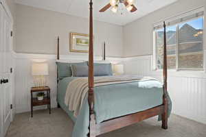 Carpeted bedroom featuring ceiling fan