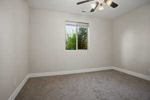 Unfurnished room with carpet and ceiling fan