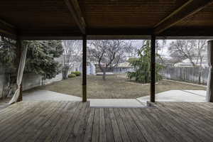 Deck with a storage unit and a patio area