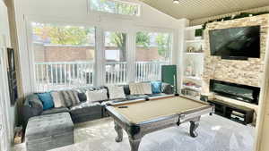 Playroom with billiards, built in shelves, vaulted ceiling, and wooden ceiling