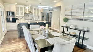 Dining area with hardwood / wood-style flooring and a barn door