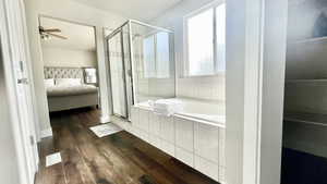 master Bathroom featuring ceiling fan, hardwood / wood-style flooring, and separate shower and tub