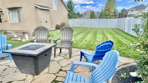 View of patio with an outdoor fire pit