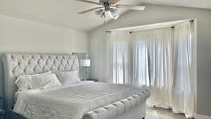 master Bedroom with ceiling fan, vaulted ceiling, and light hardwood / wood-style flooring