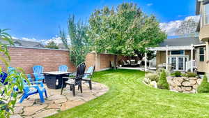 View of yard with a patio, an outdoor fire pit, a pergola, and french doors