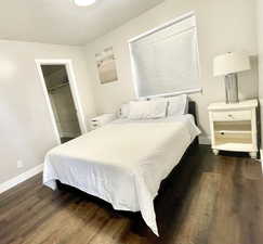 Bedroom featuring dark wood-type flooring