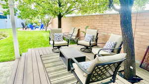 Wooden terrace featuring a yard