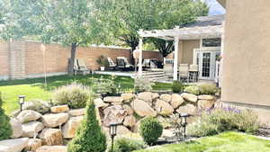 View of yard featuring a pergola and a patio area