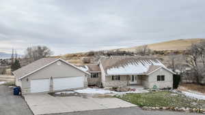 Ranch-style home with a mountain view and a garage