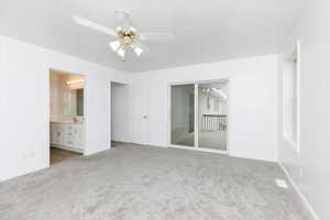 Unfurnished bedroom featuring ceiling fan, sink, light carpet, and a textured ceiling