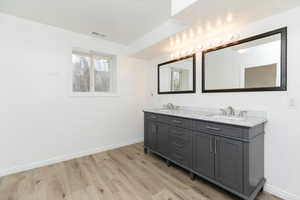 Bathroom featuring vanity and hardwood / wood-style flooring