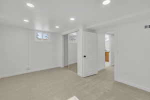 Basement with light colored carpet