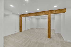 Basement with light carpet