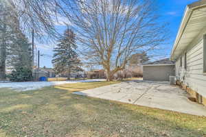 View of yard featuring a patio and central AC unit