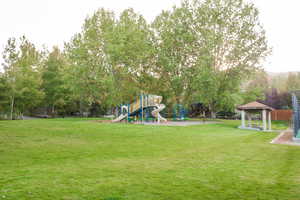 View of yard with a playground and a gazebo