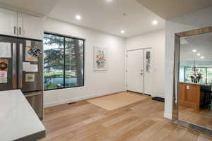 Entrance foyer featuring light wood-type flooring