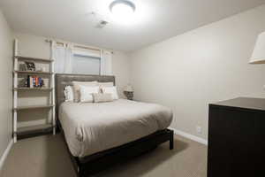 Bedroom with a textured ceiling and carpet