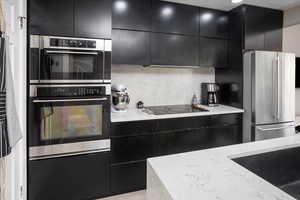 Kitchen featuring stainless steel appliances and light quartz countertops