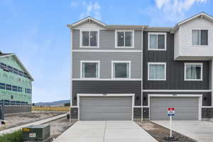 Townhome / multi-family property featuring a mountain view and a garage