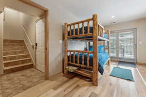 Bedroom featuring wood-type flooring and access to exterior