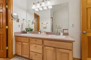 Bathroom with vanity and tile patterned flooring