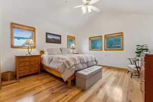 Bedroom with lofted ceiling, ceiling fan, and light wood-type flooring