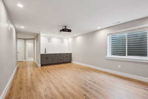 Spare room featuring sink and light hardwood / wood-style flooring