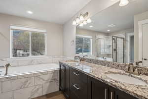 Bathroom featuring vanity and plus walk in shower