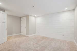 Empty room featuring light colored carpet