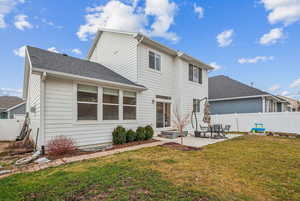 Rear view of property featuring a patio area and a lawn