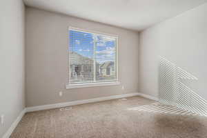 Spare room featuring carpet flooring