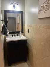 Bathroom with tile walls and vanity