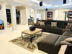 Carpeted living room featuring a raised ceiling