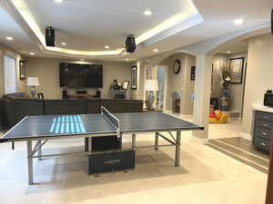 Recreation room featuring a tray ceiling