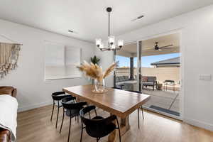 Dining room featuring a chandelier and light hardwood / wood-style flooring