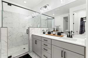 Bathroom featuring walk in shower and vanity