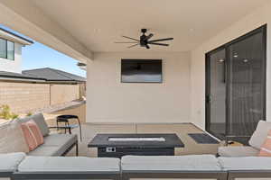 View of patio featuring an outdoor living space and ceiling fan