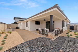 Back of property with central AC, a patio area, outdoor lounge area, and ceiling fan