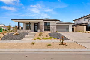 View of front of home with a garage and a porch