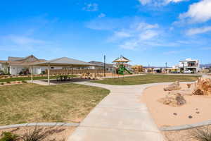 View of property's community with a gazebo, a playground, and a lawn