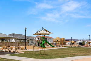 View of playground with a yard