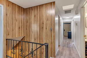 Corridor featuring wood-type flooring