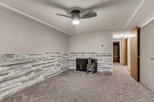 Unfurnished living room with ceiling fan and carpet floors