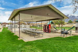 View of community with a mountain view, a lawn, and a playground