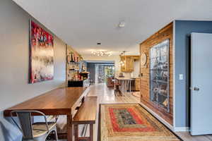 Interior space with a textured ceiling and light wood-type flooring